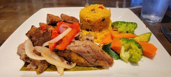 Pernil with yellow rice and plaintains.