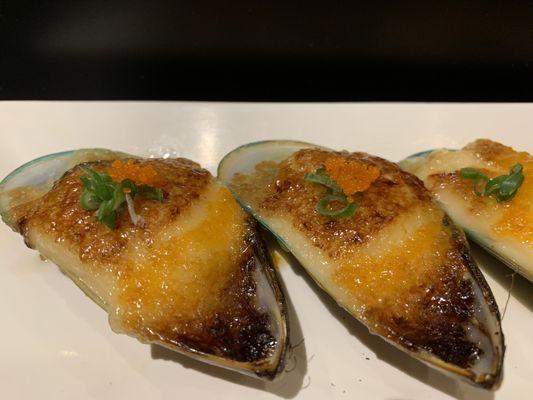 One of our most popular dishes, Bakd green mussels topped with green onion and masago drizzled with ponzu sauce