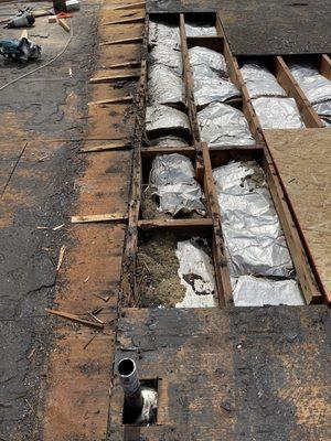 Removing all bad wood before putting a new roof on it.