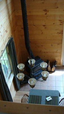 View from the loft of the wood stove in the dining area. We provide the wood free of charge.