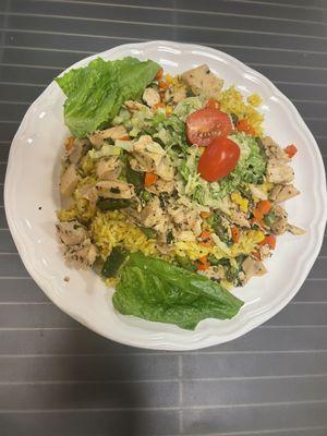 Chicken over rice with coleslaw and cherry tomatoes