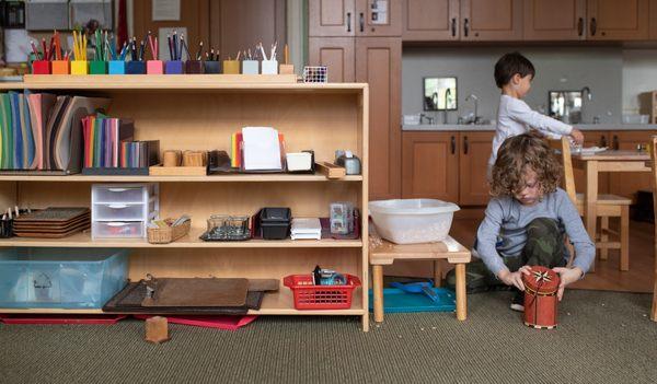 Montessori classrooms are organized so that learning materials are grouped in distinct subject areas, typically arranged on shelves in order