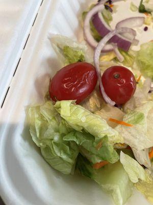 Wrinkled tomatoes, on a salad with flipped over Italian dressing