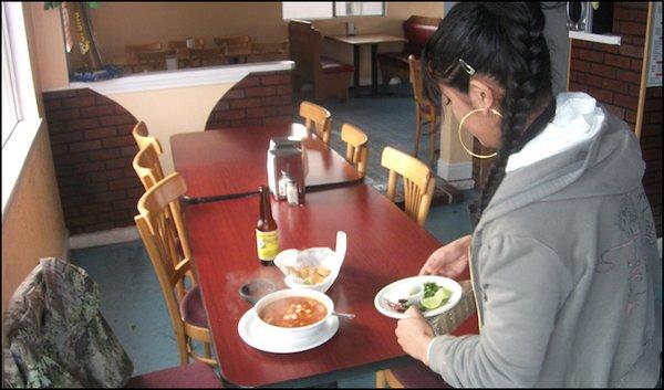 My friendly, but camera shy server, Sandra, delivers my order of menudo to the table.  She was surprised that I wanted to take her photo...