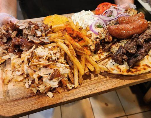 Mixed Grill - Sampling of Pork and Chicken Gyro Meat, Loukaniko, Pork, Chicken and Lamb Souvlaki, Tzatziki, Tirokafteri, Pita & Fries.