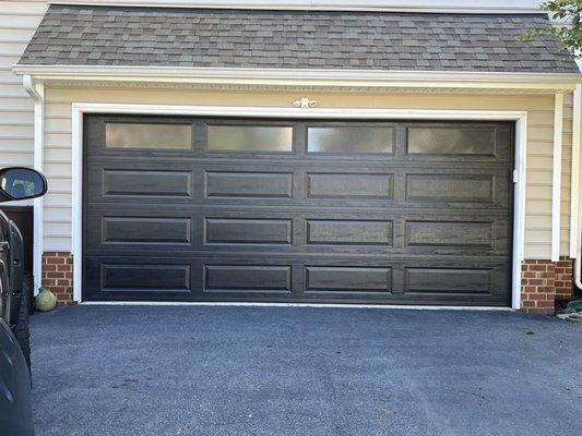 New black garage door with windows.