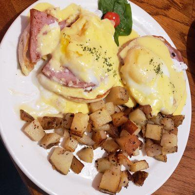 Eggs Benedict with home potatoes. Served nice and hot!