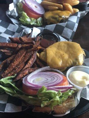 California Burgers one with steak fries the other with sweet potato fries.