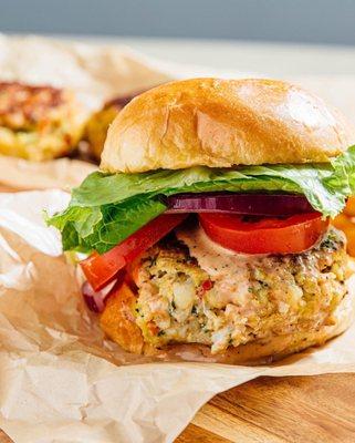 Jumbo Crab Cake Slider - 100% lump crabmeat on a toasted Brioche Roll drizzled with our signature sauce.