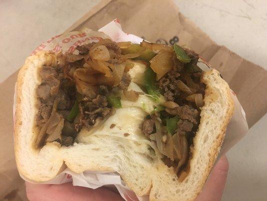 The classic has beef, provolone, green bell pepper and onion. This is looking down the center of both halves before I split the bread apart.