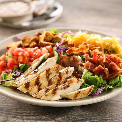 Chicken Club Salad - Tender boneless chicken breast (grilled or crispy) served on a bed of mixed greens with all of the fixings.