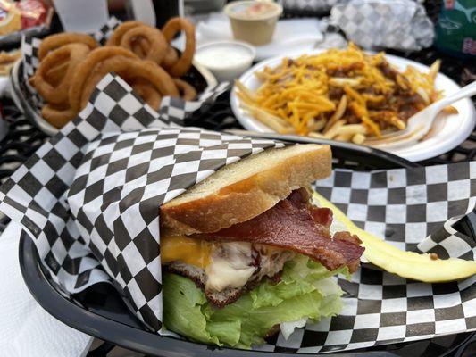 Bacon burger on sourdough, chili fries and onion rings