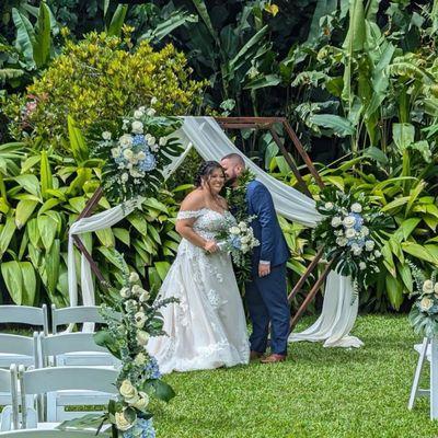 Beautiful hexagon arch and drapery offered with flower arrangements