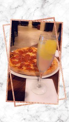 Pepparoni pizza and an adult beverage