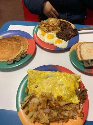 Gyro skillet, pancakes and ribeye steak with three eggs.