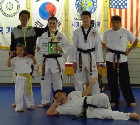 Picture of happy students and black belts after an exam.