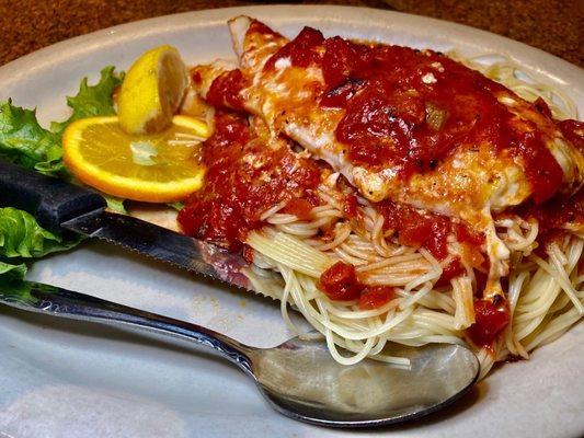 Haddock with marinara sauce on pasta.