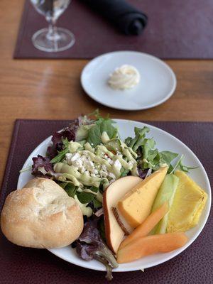 Salad and fruit and cheese plate