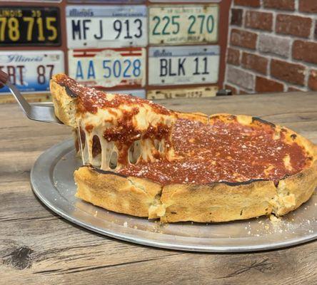 Deep dish pizza, just look at that cheese pull!