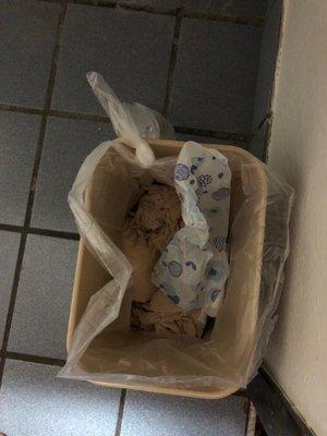 Someone left adult diapers and used pads in the garbage can in the bathroom