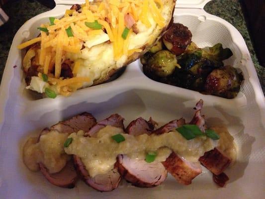 Pork loin with onion sauce, roasted Brussel sprouts and twice baked potato