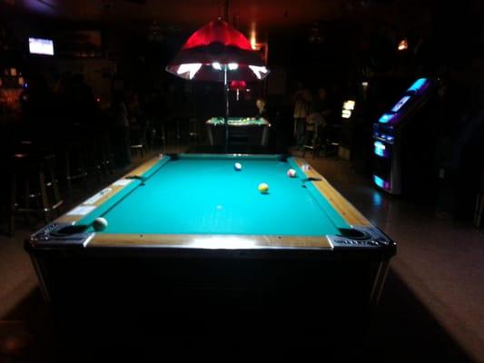 pool table (stripper pole behind it)