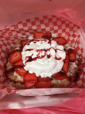 Funnel cake with strawberries and whipped cream