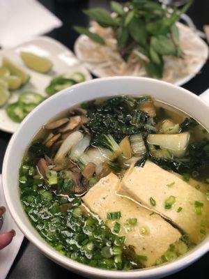 Vegetarian pho with tofu, mushrooms, onions with spinach noodles