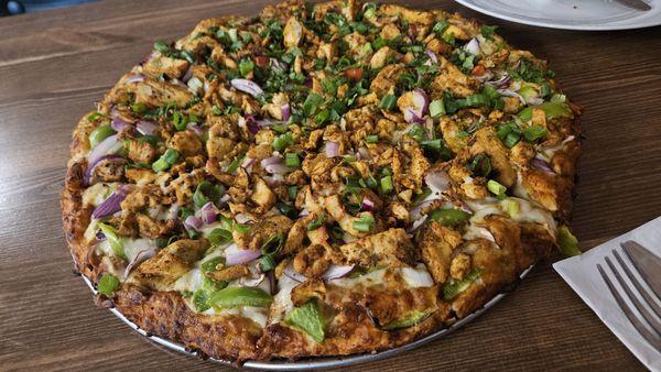 Half butter chicken and half chicken tikka masala pizza