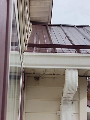 Roofing raised up near bowed vinyl and damage to soffit at end.  Kind of looks like they stepped on the gutter too.