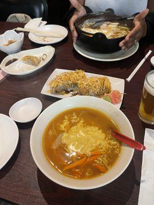 Cheesy ramen Sukiyaki Gyoza on the left and a sushi roll between the soups! Everything was good.