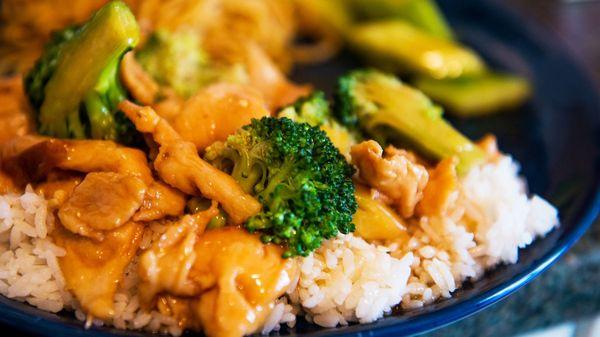 Chicken and broccoli in foreground; sweet and sour cucumbers in background