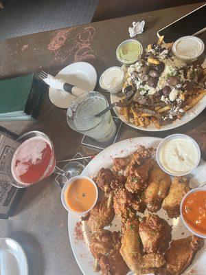 Wings with sauces on the side and Greek fries