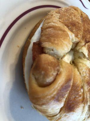 Bacon fried egg and cream cheese on a croissant