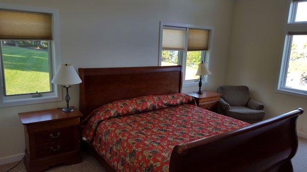 Upstairs master bedroom with a King-sized bed, private bath, and a second balcony overlooking the lake