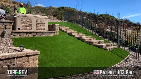 Full view of the Patriot 103 Pro install in a front yard with hardscape