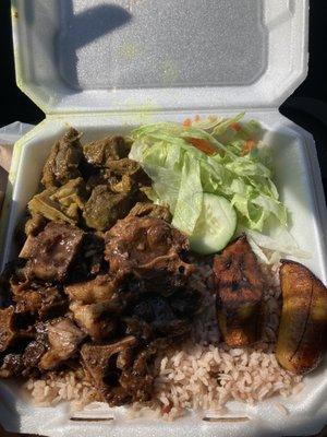 Combo plate of oxtail, curry goat, with rice and peas.