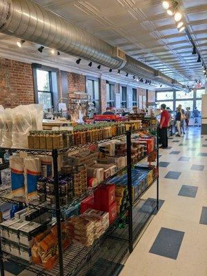 Shopping section with a view toward the deli counter (nearer) and coffee/pastry area (closer to front windows)