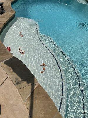 Attention to detail, such as unique koi tiled on the children's steps.  The coping is had cut and installed.  Perfection in pool design.