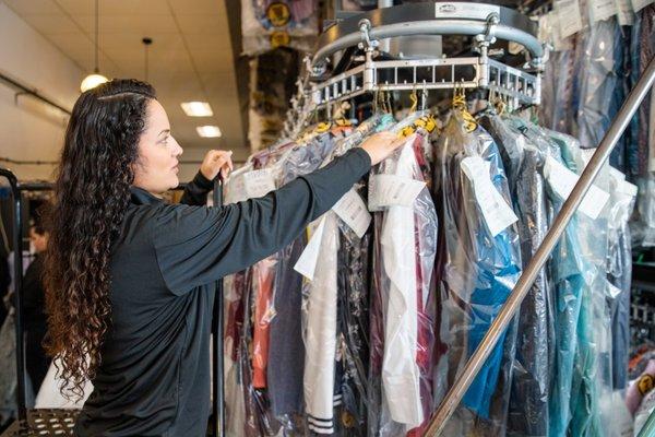 A friendly, professional ZIPS Cleaners Team Member quickly finds a customer order on our state-of-the-art conveyor...