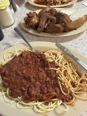 Spaghetti Pasta With Meat Sauce and a fried chicken dinner