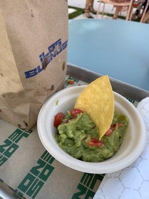 Guacamole with chips in a bag.