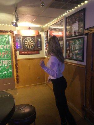 Susan throwing 3 darts at once