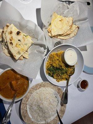 Garlic naan bread, regular butter naan, chicken tikka masala and lamb biryani. Spicy hot sauce was good!