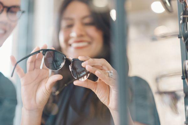 Adriana, our optician, finding the perfect pair of Tom Ford sunglasses for our patient.