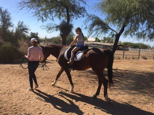 Jackie taking a youngster on a ride with Prinze of Fire