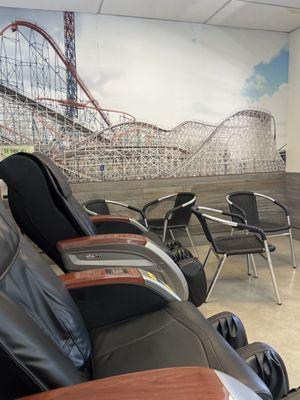 Massage chairs and waiting seats with a rollercoaster backdrop for scenery. Clean room, great temperature and family friendly TV shows.