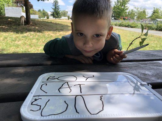 Practicing our letters at the park! Being 6 is fun.