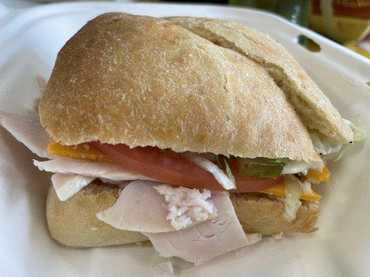 Ciabatta with turkey, bacon, and cheese with lettuce and tomato and mayo