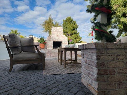 The finished patio with Holland pavers a rustic fireplace and pillar to match for balance.